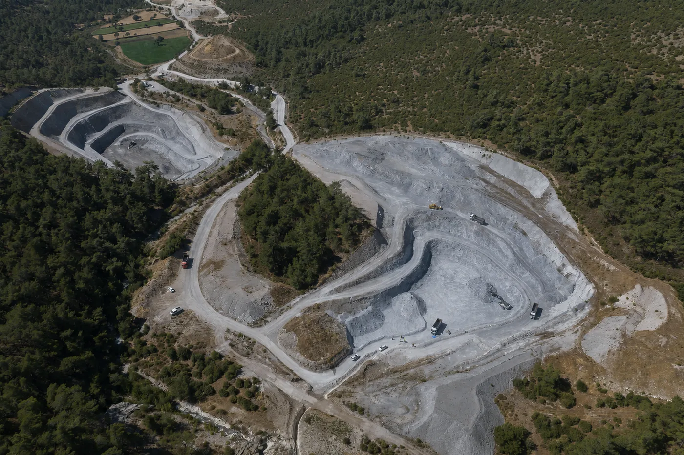 Aerial view of two adjoining perlite quarries connected by haul roads