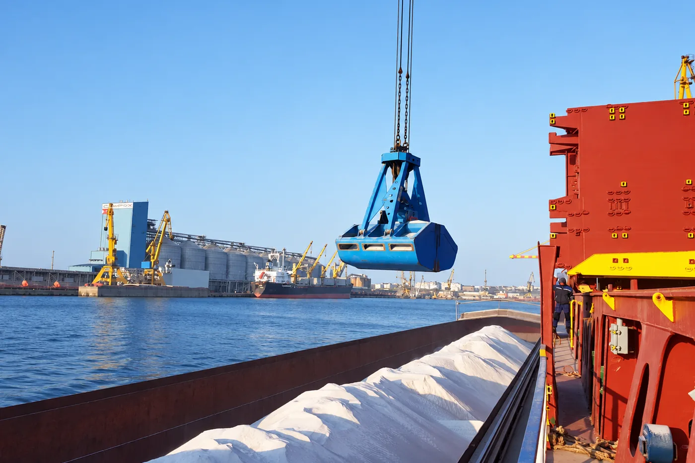 Grab crane loading perlite into a vessel hold