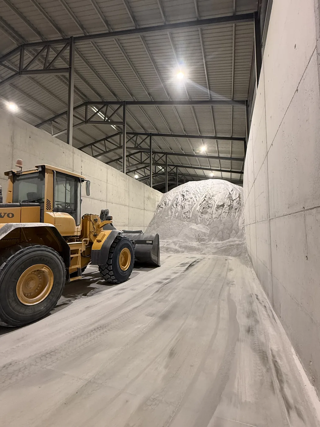 Wheel loader moving perlite inside the warehouse