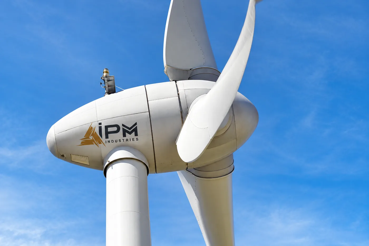 IPM wind turbine nacelle against a blue sky